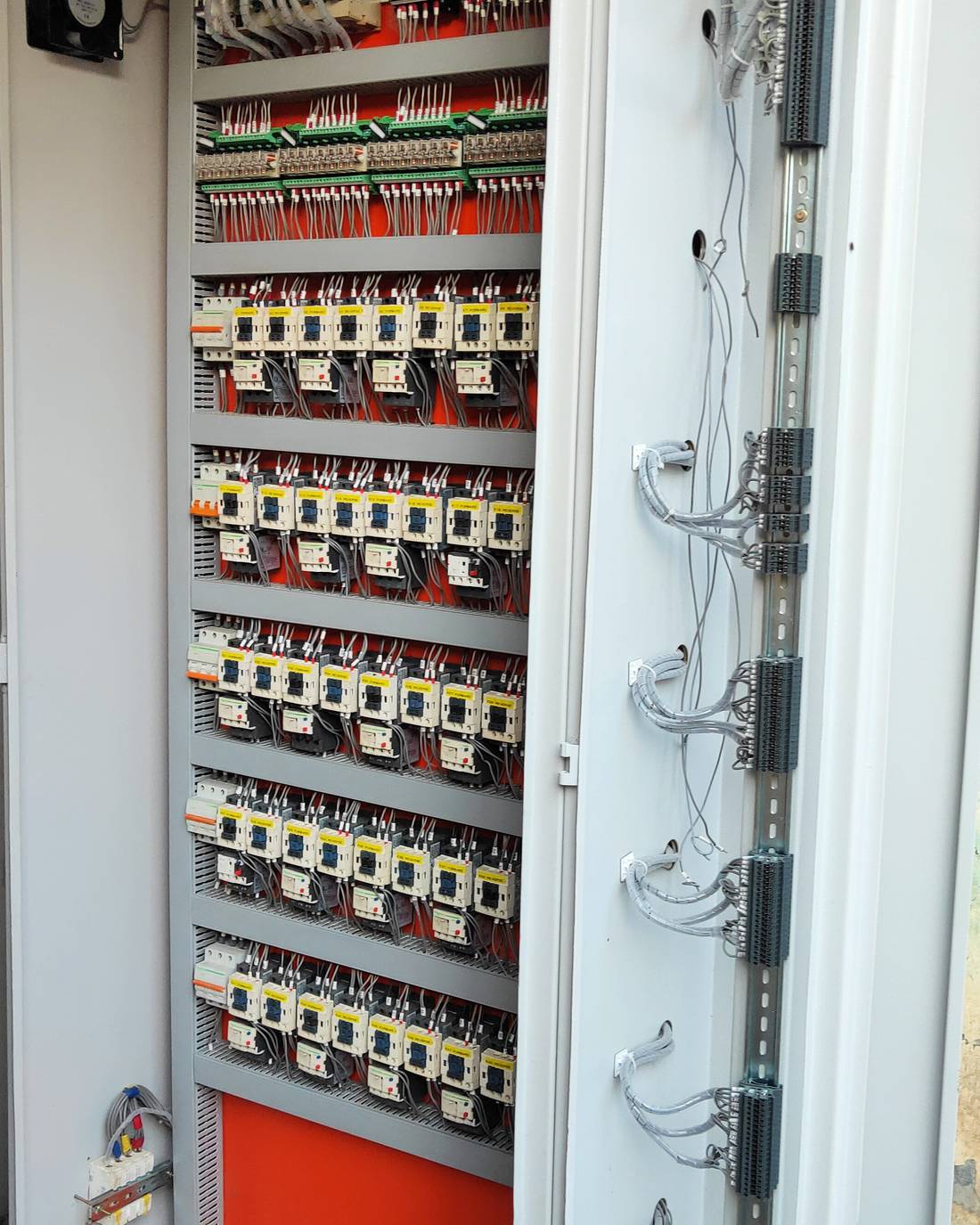 Open PLC control panel showing ferruled wiring, relay cards and labelled forward-reverse contactors, built by FutureTech Electricals Faridabad