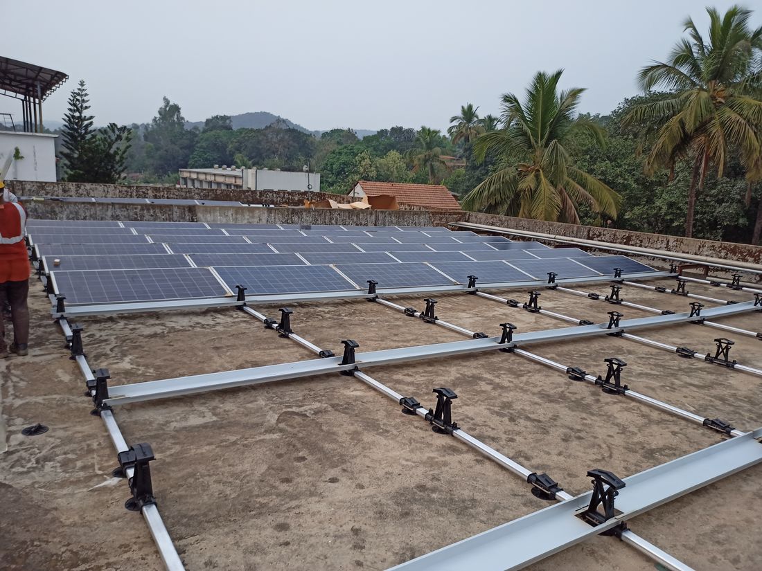 Solar modules being laid and clamped onto mounting rails